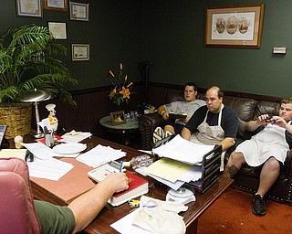 Geoffrey Hauschild|The VIndicator.8.5.2010.OVTC residents Brian Druschel, Steve Petracci and Kyle Ulner sit in the office of chef Al Franco while working on an upcoming catering project.