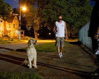 Geoffrey Hauschild|The Vindicator.8.6.2010.Students walk the center's dog, Hannah, along Florencedale Ave outside the center on Youngstown's north side.