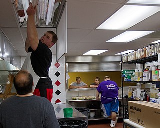 Geoffrey Hauschild|The Vindicator.9.21.2010.OVTC intern Kyle Ulner replaces a light bulb in Hope Kitchen inside the facility.
