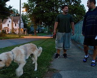 9.21.2010.John Walsh and Scott Fabry walk the center's dog, Hannah, in front of the OVTC facility on Youngstown's North Side.