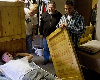 Geoffrey Hauschild|The Vindicator.10.14.2010.Dennis McKenney lies down on a newly assembled bed as student Anthony Sanders, Executive Director Roy Barnett and Director of Operations Bob Pavlich, work to create more space for future residents at Ohio Valley Teen Challenge.