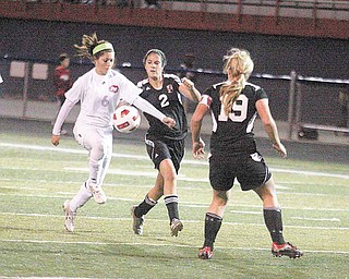 (6) Tori Koch of Fitch tries to get past (2) Selena Dasari and (19) Katie Carlisle during their game Wednesday night in Austintown.