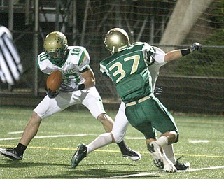 FOOTBALL - (10) Jordan Markota pulls in a pass and scores as (33) Jeff Podolsky blocks (37) Mark Murphy during their game Thursday night in Akron. - Special to The Vindicator/Nick Mays