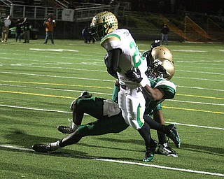 FOOTBALL - (26) Akise Teague fights for the goal line as (37) Mark Murphy and (47) Dante Booker try to make the play during their game Thursday night in Akron. - Special to The Vindicator/Nick Mays