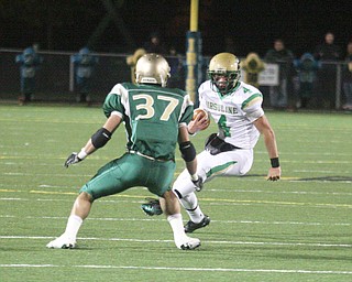 FOOTBALL - (4) Paul Kempe looks for running room as (37) Mark Murphy tries to make the play during their game Thursday night in Akron. - Special to The Vindicator/Nick Mays