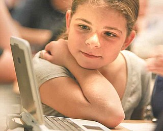 Fourth-grader Bailee Thorn participates in an interactive poetry lesson on “The Raven” by Edgar Allan Poe Thursday. Ninth-graders at Jackson-Milton High School helped to teach fourth-graders during their language arts classes.