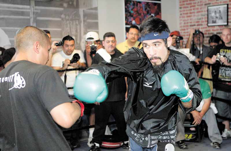 Antonio Margarito, right, of Mexico, trains with Robert Garcia during a workout for his upcoming fight with Manny Pacquiao, Thursday, Oct. 28, 2010, in Los Angeles. Nearly two years after a hand-wrapping scandal nearly ended his boxing career, Margarito still insists he didn't know his former trainer had placed illegal pads atop his fists. He's still banned from fighting in California and Nevada. (AP Photo/Jae C. Hong)
