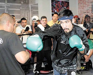 Antonio Margarito, right, of Mexico, trains with Robert Garcia during a workout for his upcoming fight with Manny Pacquiao, Thursday, Oct. 28, 2010, in Los Angeles. Nearly two years after a hand-wrapping scandal nearly ended his boxing career, Margarito still insists he didn't know his former trainer had placed illegal pads atop his fists. He's still banned from fighting in California and Nevada. (AP Photo/Jae C. Hong)