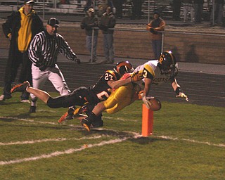 FOOTBALL - (3) Adam Coppock reaches into the end zone as (27) Kaleb Baker makes the tackle Friday night in Mineral Ridge. - Special to The Vindicator/Nick Mays