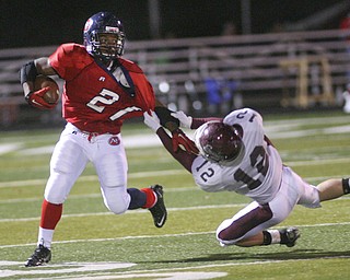 ROBERT  K.  YOSAY  | THE VINDICATOR --..Trying to drag dow  Fitchs #21  Bruce Reed is Boardmans #12  Tyler Walls during second quarter action as.Boardman battled  Fitch at Fitch Stadium Friday Night as the Regular season drew to a close -.... -30-(AP Photo/The Vindicator, Robert K. Yosay)