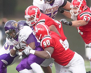 Geoffrey Hauschild|The Vindicator.YSU's Obinna Ekweremuba(90) Torrance Nicholson (94) and John Sasson (53) bring down Iowa's Carlos Anderson (1) during the second half of a game at Stambaugh Stadium on Saturday afternoon.