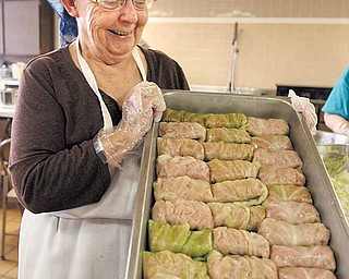 Mary Hallewell shows off a pan of freshly made stuffed cabbage rolls (halupki) waiting for sauce to be added that will be sold from 11 a.m. to 2 p.m. today at Mahoning United Methodist Church, 2214 Mahoning Ave., Youngstown. The church sells the cabbage rolls as a weekly fundraiser, which happens to coincide with Election Day this week. In addition to the halupki, the kitchen crew also makes and sells haluski, a dish of noodles and cabbage. .