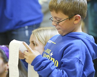 ROBERT K. YOSAY | THE VINDICATOR --..Vincent Sciorintino ( mikes son ) reads a printout as his dad Mike took an early lead in The November election had many incumbents and levies pass.... -30-..(AP Photo/The Vindicator, Robert K. Yosay)