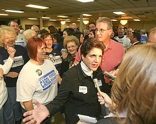 ROBERT K. YOSAY | THE VINDICATOR --..Carol Rimedio Righetti with her husband and a group of suporters celebrate her win at the ITAM club on Meridian Rd.The November election had many incumbents and levies pass.... -30-..(AP Photo/The Vindicator, Robert K. Yosay)