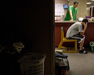 Geoffrey Hauschild|The Vindicator.6.14.2010.OVTC Intern, Pete Naudaud, watches as a student, requesting anonymity, makes a call to his mother in order to be picked up after 6 days in the program. Unable to arrange a ride with his parents, the student, who struggled with an addiction to oxycotin, was taken to the Rescue Mission after cursing out his mother on the phone. "All they tell you to do is lay in bed and pray but sometimes prayer don't fix everything," said the student who did add the program helped him realize how he was hurting others.