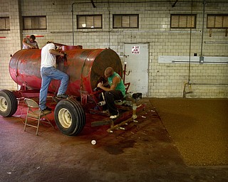 Geoffrey Hauschild|The Vindicator.6.15.2010.While working at the Canfield fairgrounds, OVTC students sand down a piece of equipment to be repainted.