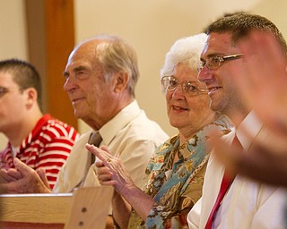 Geoffrey Hauschild|The Vindicator.6.25.2010.OVTC student, Jesse Repko, along with his grandparents and brother, applaud during a service honoring Jesse's graduation and the graduation of another student while at Youngstown Christian Assembly.