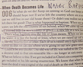Geoffrey Hauschild|The Vindicator.6.25.2010.Underlines bring attention to a reading about water baptism to be referenced during the water baptism of two OVTC graduates at Youngstown Christian Assembly.