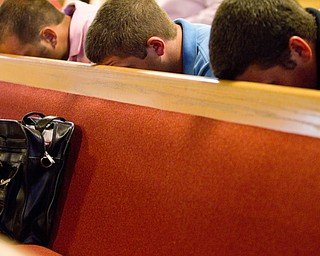 Geoffrey Hauschid|The Vindicator.6.25.2010.OVTC residents rest their head on the pew in front of them while attending a graduation ceremony and water baptism for two graduates of OVTC at Youngstown Christian Assembly.
