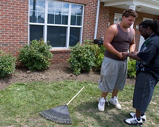 Geoffrey Hauschild|The VIndicator.7.1.2010.OVTC resident John Walsh (left), prays with Stacey Thomas outside of Thomas' mother's home in Arlington Heights. "They keep me on fire," says Thomas, who works with the men at the Covelli Centre, referring to inspiring words about the holy spirit "and I try to do the same for them."