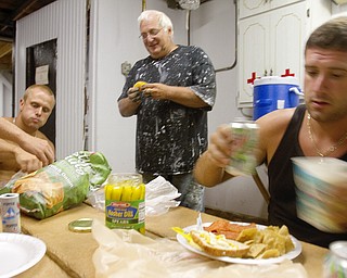 Geoffrey Hauschild|The Vindcator.7.28.2010.OVTC students, Eric Gorniak (left) and David Long (center) eat lunch with intern, Jesse Repko, at the Canfield Fair Grounds.