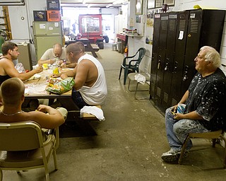 Geoffrey Hauschild|The VIndictor.8.3.2010.OVTC student, David Long, sits at right, while OVTC students and maintenance workers eat lunch at the Canfield Fairgrounds.