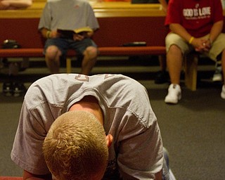 Geoffrey Hauschild|The Vindcator.8.4.2010.OVTC resident Anthony Sanders prays during the group's weekly Wednesday night church service at Youngstown Christian Assembly. The men have chapel service every morning, and typically attend a church service every Wednesday evening and Sunday morning.