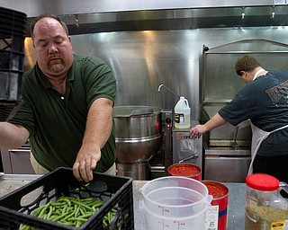 Geoffrey Hauschild|The Vindicator.8.5.2010.Chef Al Franco and Kyle Ulner work in the kitchen to complete an upcoming catering order at OVTC.
