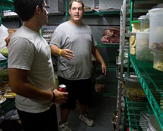 Geoffrey Hauschild|The Vindicator.OVTC students Michael Pinkerman and Bryan Druschel work in the center's walk-in cooler for an upcoming catering event.