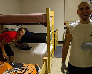 Geoffrey Hauschild|The Vindicator.8.6.2010.OVTC resident Darren Vath (left) picks up clothes and straightens up his bed after intern Sean Wilson (right) messed them up for being given a hard time in the residential wing of the center on Youngstown's North Side.