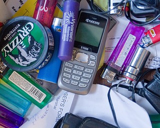 Geoffrey Hauschild|The Vindicator.10.20.2010.Lighters, cell phones, tobacco products, pill boxes and other contraband taken from students fill a drawer in Bob Pavlich's desk at OVTC.