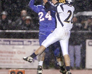ROBERT K. YOSAY | THE VINDICATOR..Broken play as McDonalds #28 Stephen Mohamed  is blocked by #24 Reserve Thomas Benyo - during first quarter action.. McDonald @ Western Reserve - first round .Ó--30-..