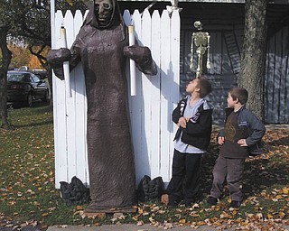 Nathan and Nicholas Burgermyer show some bravery, despite not wanting to go into the annual haunted house set up by Jason Burgermyer of Cortland and his nephews Craig Bash and Mike Burgermyer. Photo sent in by Barb Bradford.
