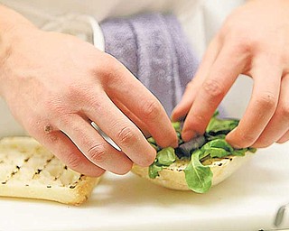 A Mahoning County Career and Technical Center student prepares a sandwich before The Bistro’s opening week. The menu includes soups, salads, sandwiches and entrees and dessert.