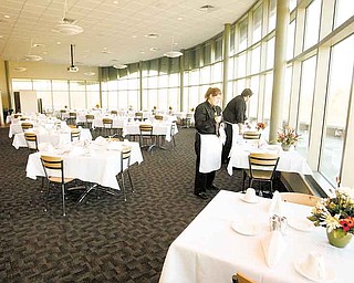 Students set tables in The Bistro’s dining room. The restaurant at the Mahoning County Career and Technical Center opened to school personnel last week for a practice run. 