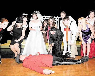 Cast members react to the apparent death of a wedding guest during a dress rehearsal of “Bruce and Tina’s Wedding” Tuesday. The play is the first interactive murder mystery performed at Canfield High School.