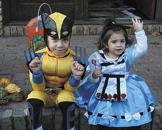 Carmine White, 4, strikes a pose as Wolverine, while Gemma White, 19 months, is sitting pretty as Alice in Wonderland. They live in Canfield. The photo was sent in by their mom, Joanna White.