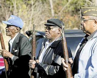 VFW Donald Lockett Post 6488 firing squad stands at order arms after firing a salute during Thursday’s Veterans Day program at the post in Youngstown. From left are Jesse Duke, Ronell Carter and Lacy Hill.