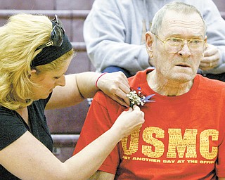 William D LEwis The Vindicator Jennifer Sehon-Deans pins a corsage on her father James Sehon of Liberty during a Veterans Day program at Liberty HS Thursday. Veterans from Liberty were honored. Sehon served in hte MArines.
