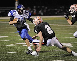 Lakeview's Louie Novakovich runs the ball against Chagrin Fall's Spencer Diedrich, 2, during their game at Arura on friday night. Photo/Mark Stahl