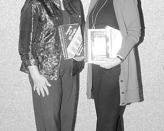Nick Mays | Special to The Vindicator: Displaying the cookbooks that will provide recipes for foods and baked goods to be featured at the Holiday Brunch and Sweet Shoppe to be sponsored by the Angels of Easter Seals are Joan Zarlenga, left, and Phyllis Bacon, co-chairwomen for the event.