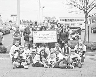 In a league of their own: In the spirt of teamwork taught by youth sports, Greenwood Chevrolet is teaming up with Austintown Junior Soccer League to provide their players and coaches with soccer kits filled with equipment bags, soccer balls, sport cones, practice jerseys and T-shirts, a monetary donation and the chance to raise funds. Above, a one-time donation check is presented from Greenwood to the Austintown league. The league has the opportunity to raise as much as $10,000 through a fundraiser in which a lucky recipient will win the choice of a 2010 Chevrolet Equinox or Malibu. Another winner will receive a home entertainment package. Greenwood and other area Chevrolet dealerships are donating the prizes to participating leagues. They can use the funds in any way they choose, and 100 percent of the proceeds go to the leagues. Some leagues plan to grant scholarships to families who cannot afford to enroll their children in the league, and others will use the funds to improve fields and equipment.
