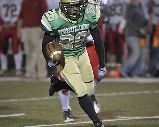 Ursuline's Akise Teague runs the ball against Norwayne during their game at Green on Saturday night. Photo/Mark Stahl