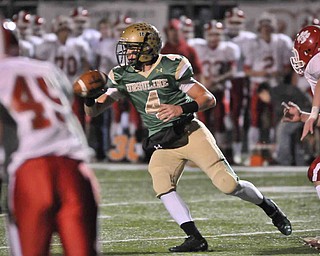 Ursuline QB Paul Kempe,4, set sto deliver the ball to a teammate against Norwayne during their game at Green on Saturday night. Photo/mark Stahl