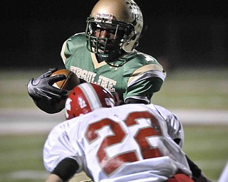 Ursulines Trevor Smith runs over Norwayne's Dustin Grier during their game at Green on Saturday night. photo/Mark Stahl