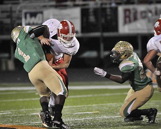 Ursuline's Trevor Smith, 1, takes down Norwayne QB Adam Wallace during their game at Green on Saturday night. Photo/Mark Stahl
