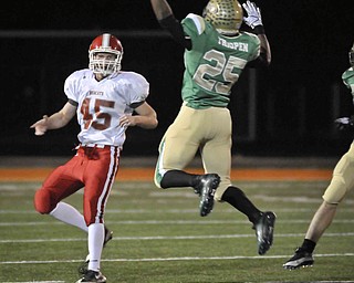 Ursuline's Tramaine Thigpen puts the preasure on Norwayne QB Adam Wallace during their game at Green on Saturday night. Photo/Mark Stahl