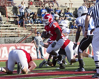 Geoffrey Hauschild|The Vindicator.YSU's Randy Louis (5) finds a hole and runs the ball into the endzone for a touchdown during the third quarter of a game at YSU's Stambaugh Stadium on Saturday afternoon.