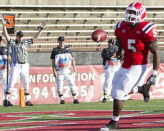 Geoffrey Hauschild|The Vindicator.YSU's Randy Louis (5) tosses the ball aside after finding a hole and running the ball into the endzone for a touchdown during the third quarter of a game at YSU's Stambaugh Stadium on Saturday afternoon.