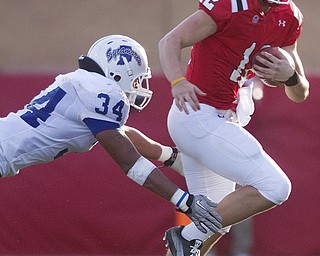 Geoffrey Hauschild|The Vindicator.Indiana State's Jacolby Washington (34) brings down YSU's quarterback, Kurt Hess (12), as he tried to scramble during the third quarter of a game at YSU's Stambaugh Stadium on Saturday afternoon.